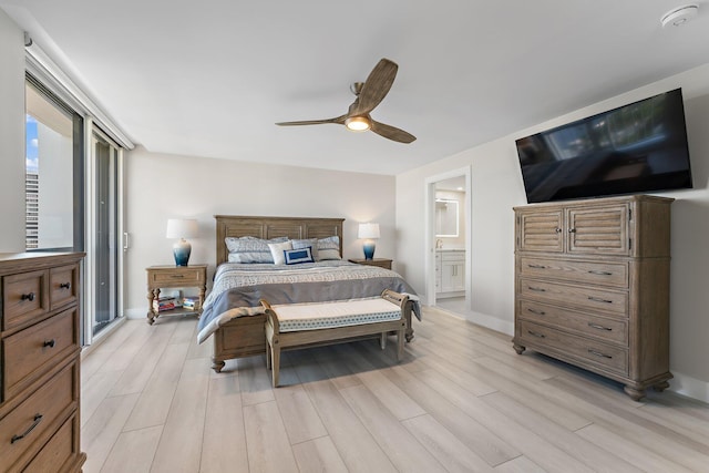 bedroom featuring ceiling fan, light wood-type flooring, and ensuite bathroom