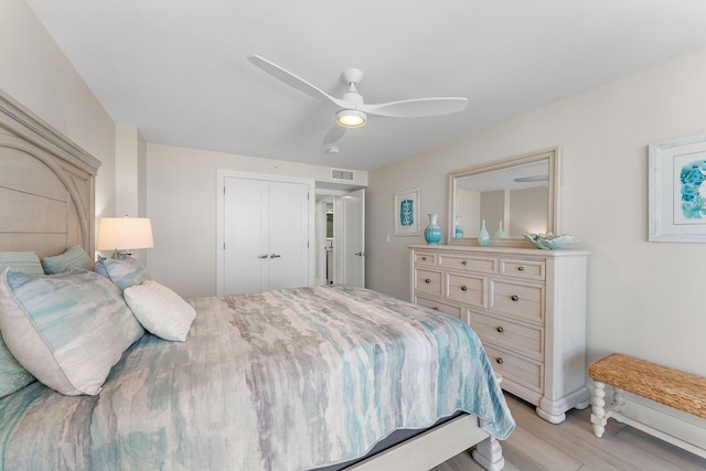 bedroom featuring ceiling fan, a closet, and light hardwood / wood-style flooring