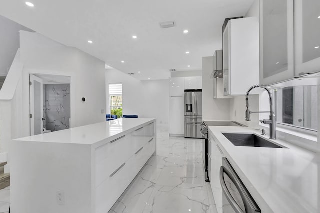 kitchen with white cabinetry, sink, dishwashing machine, stainless steel refrigerator with ice dispenser, and a spacious island