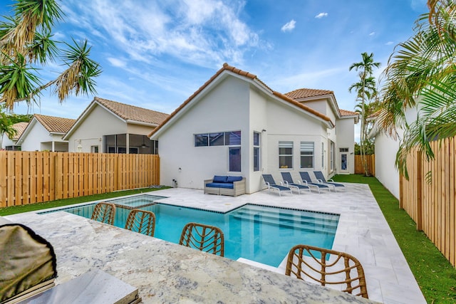 view of pool featuring an outdoor living space, an in ground hot tub, and a patio area