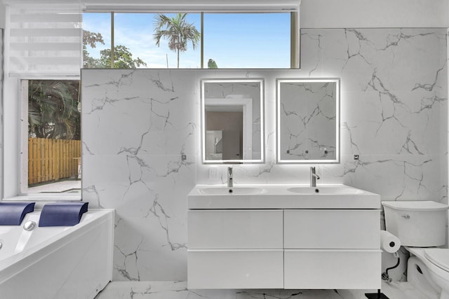 bathroom featuring toilet, vanity, and tile walls