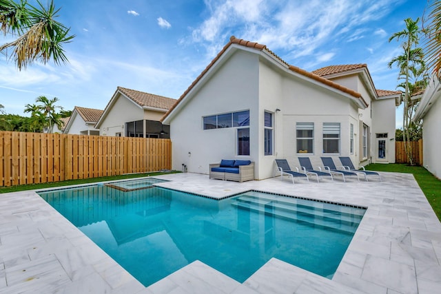 view of pool featuring a patio and an in ground hot tub