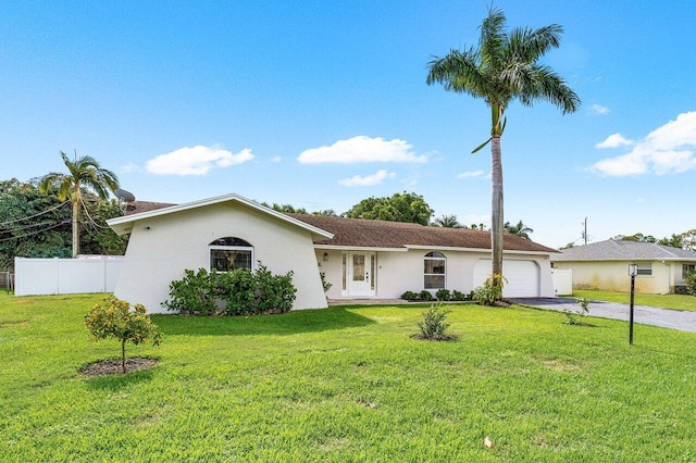 ranch-style house featuring a front yard and a garage