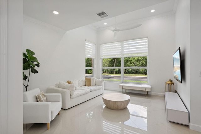 living room with ceiling fan, light tile patterned flooring, and ornamental molding