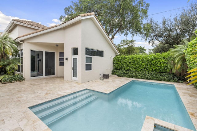 view of pool featuring a patio and central air condition unit