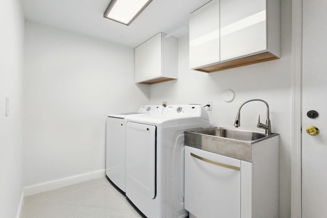 laundry room featuring independent washer and dryer, sink, and cabinets