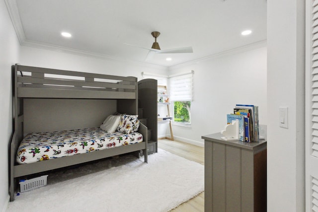 bedroom with light hardwood / wood-style flooring, ornamental molding, and ceiling fan