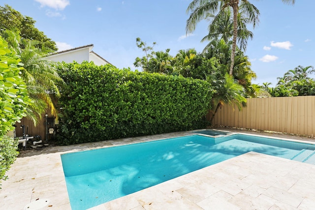 view of pool with an in ground hot tub and a patio area