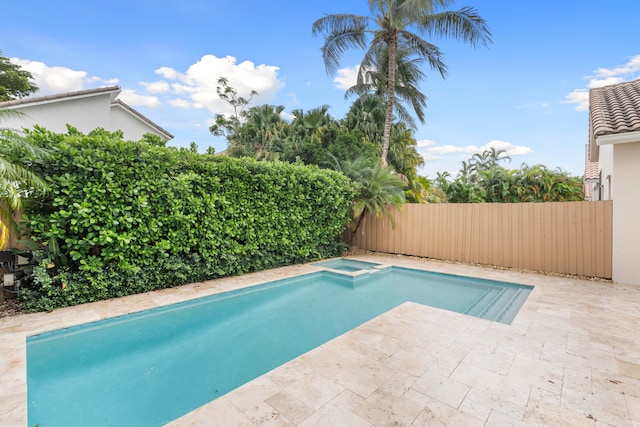 view of pool featuring an in ground hot tub