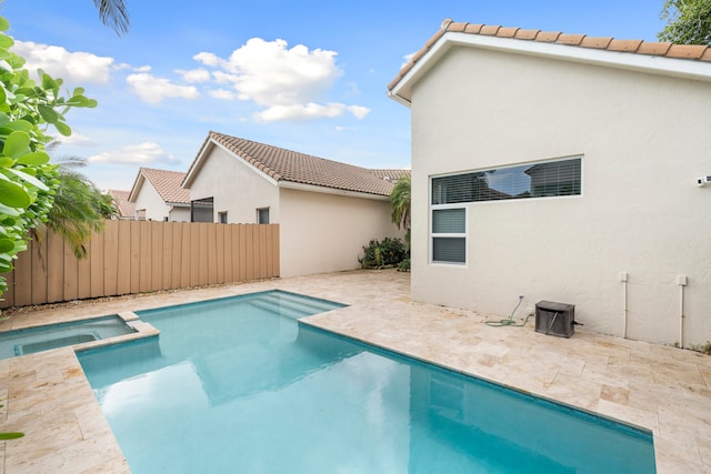 view of swimming pool featuring an in ground hot tub and a patio area