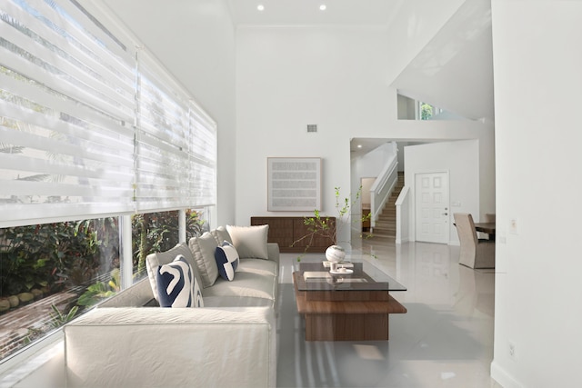 living room with a high ceiling and plenty of natural light