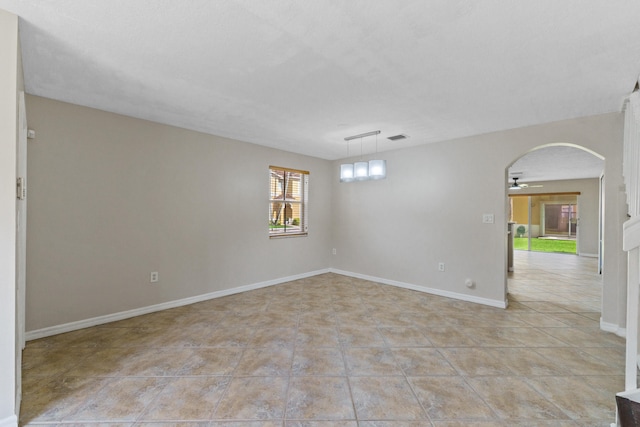 spare room featuring light tile patterned floors and ceiling fan