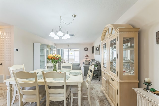 dining space with an inviting chandelier