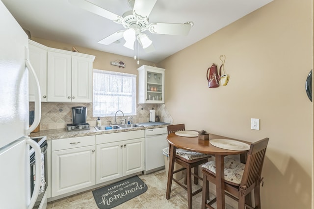 kitchen with white cabinets, decorative backsplash, sink, ceiling fan, and white appliances