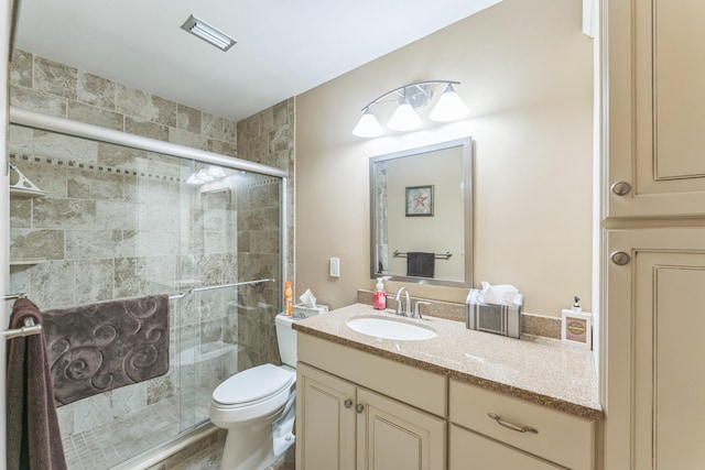 bathroom with an enclosed shower, vanity, and toilet