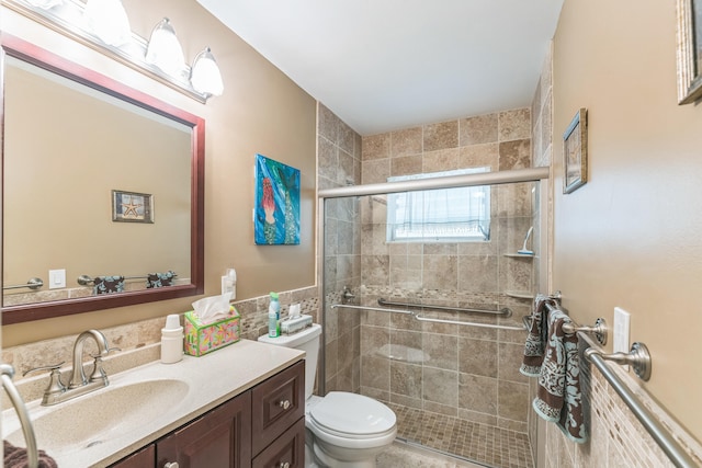 bathroom featuring walk in shower, vanity, and toilet