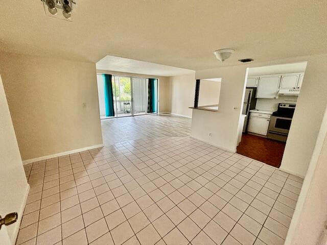 unfurnished living room with light tile patterned flooring