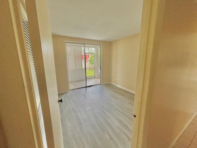 spare room with light hardwood / wood-style flooring