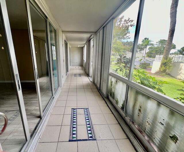 hall featuring light tile patterned floors