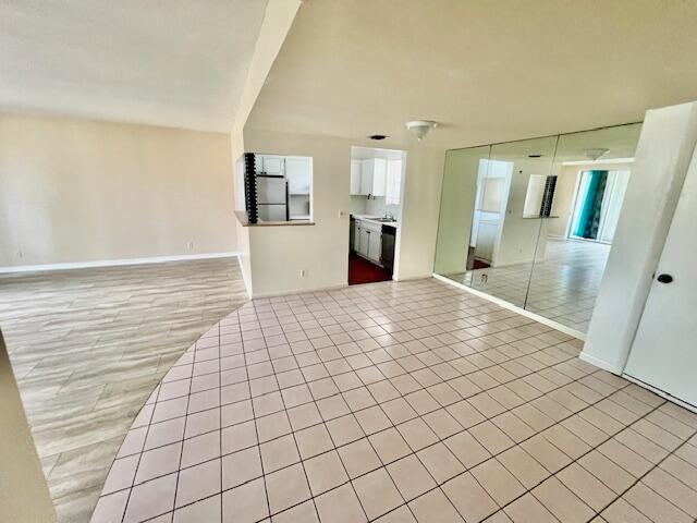 unfurnished living room with light tile patterned flooring