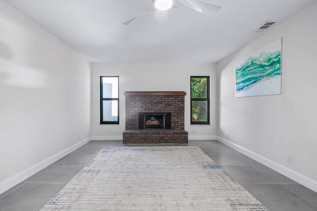 living room with ceiling fan and a brick fireplace