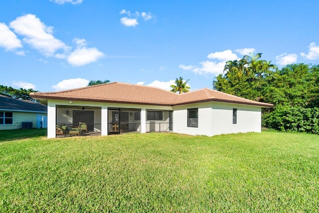 back of house featuring a sunroom, ceiling fan, cooling unit, and a yard