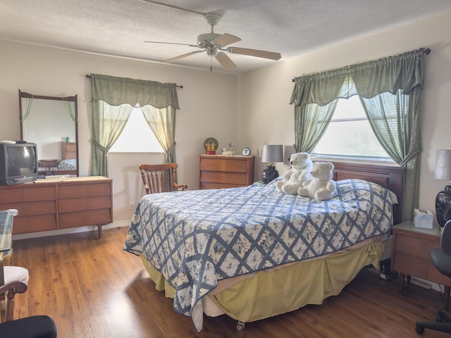 bedroom with hardwood / wood-style flooring, ceiling fan, a textured ceiling, and multiple windows