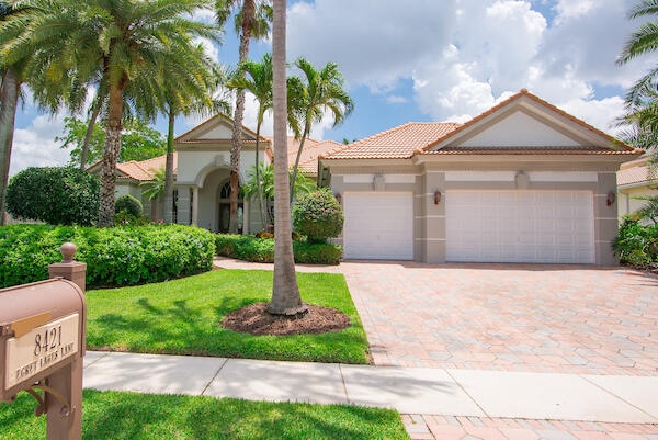 mediterranean / spanish-style home featuring a garage and a front yard