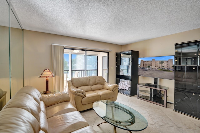 living room with light tile patterned floors and a textured ceiling