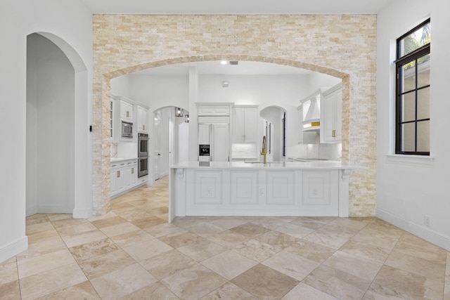 full bathroom with a high ceiling, baseboards, and vanity