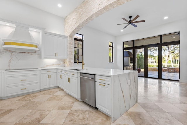 kitchen featuring dishwasher, a peninsula, black electric stovetop, premium range hood, and a sink