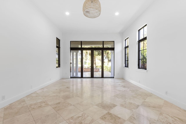 empty room with recessed lighting, baseboards, and french doors