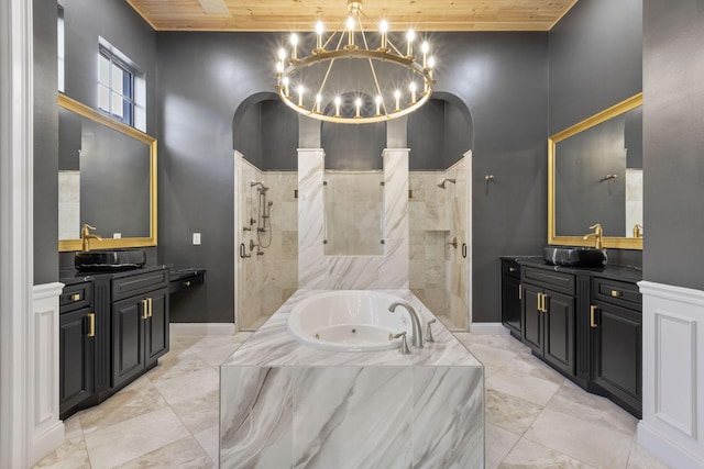 bathroom with a garden tub, two vanities, a sink, wooden ceiling, and walk in shower