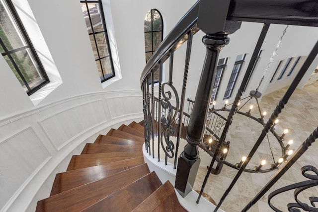 stairway featuring a decorative wall