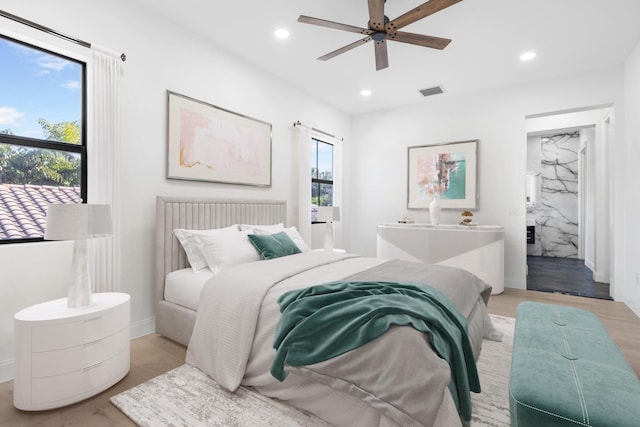 bedroom with light wood finished floors, baseboards, visible vents, and recessed lighting