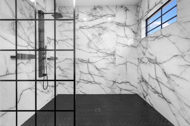 details featuring a marble finish shower