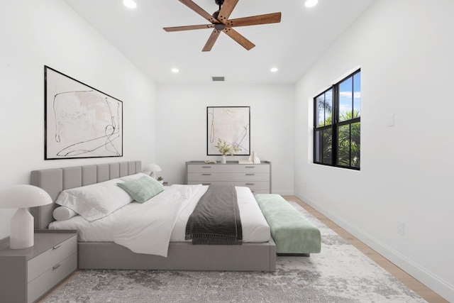 bedroom featuring baseboards, light wood finished floors, visible vents, and recessed lighting