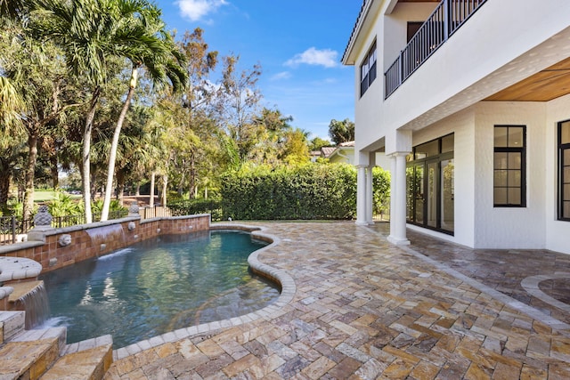 view of swimming pool with a patio area and a fenced in pool