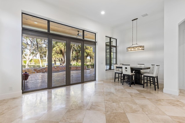 interior space with baseboards, visible vents, arched walkways, and recessed lighting