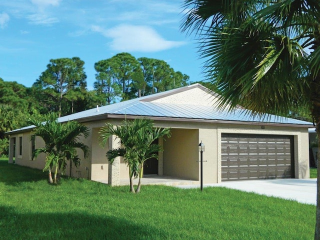 view of front of property with a front yard and a garage