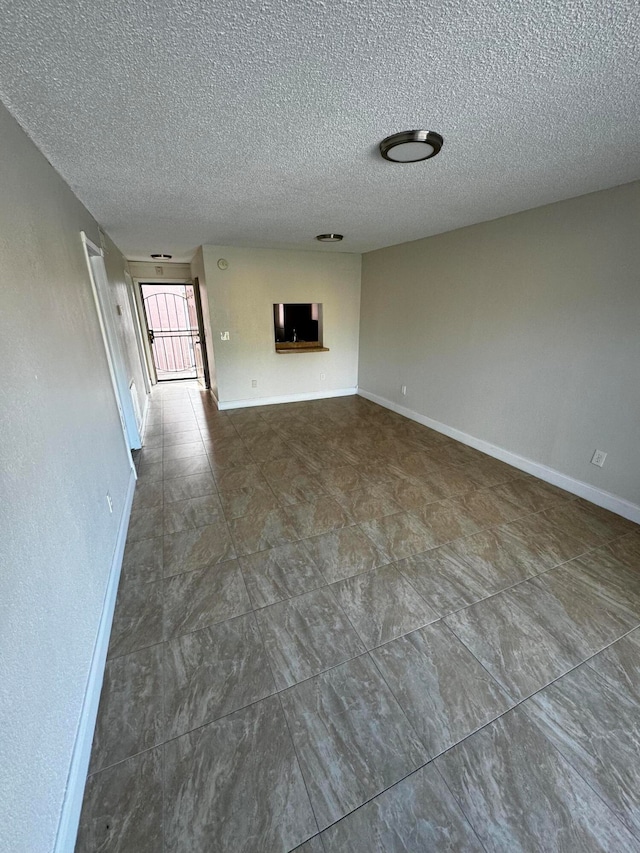 unfurnished living room with a textured ceiling