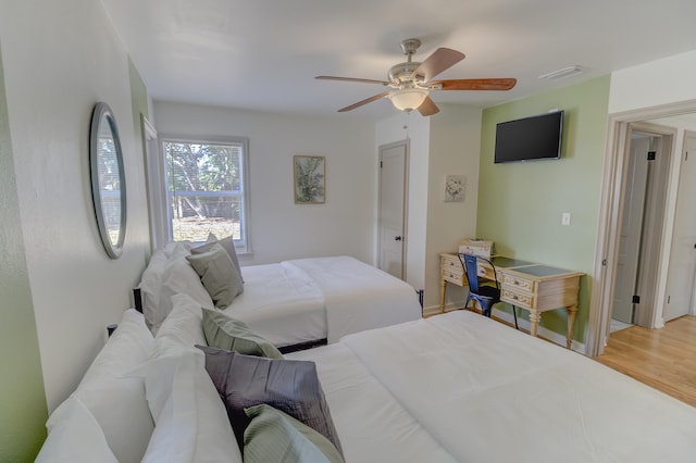 bedroom with hardwood / wood-style floors and ceiling fan