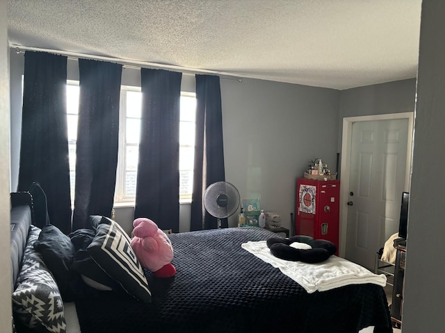 bedroom with multiple windows and a textured ceiling