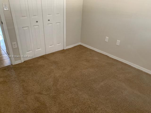 unfurnished bedroom with a closet and carpet