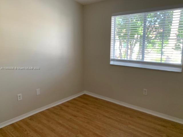 empty room with hardwood / wood-style floors