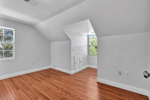 bonus room featuring lofted ceiling and light wood-type flooring