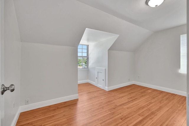 bonus room featuring light hardwood / wood-style floors and lofted ceiling