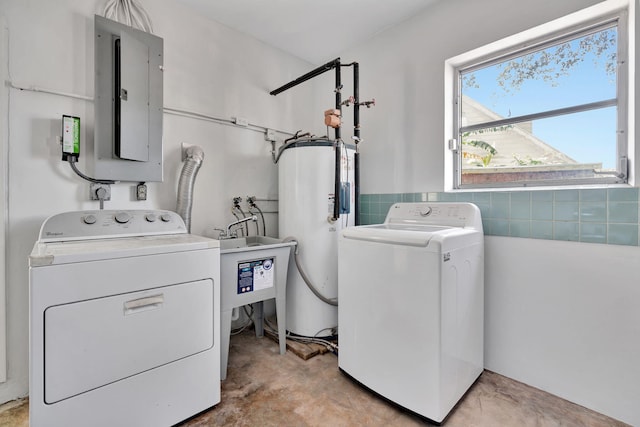 laundry area featuring electric panel, gas water heater, and washing machine and dryer