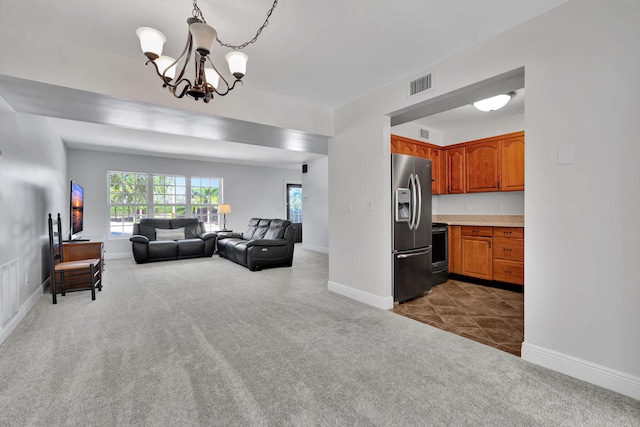 living room featuring carpet flooring and a chandelier