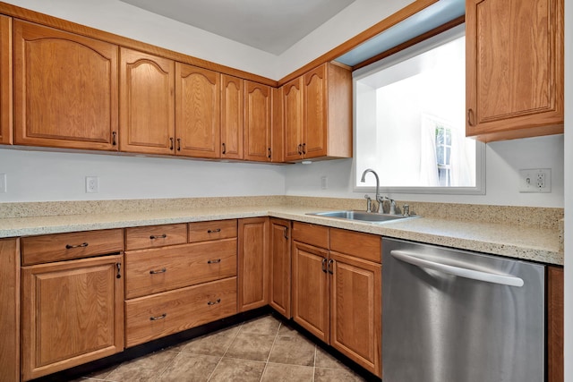 kitchen with stainless steel dishwasher, light tile patterned flooring, light stone countertops, and sink